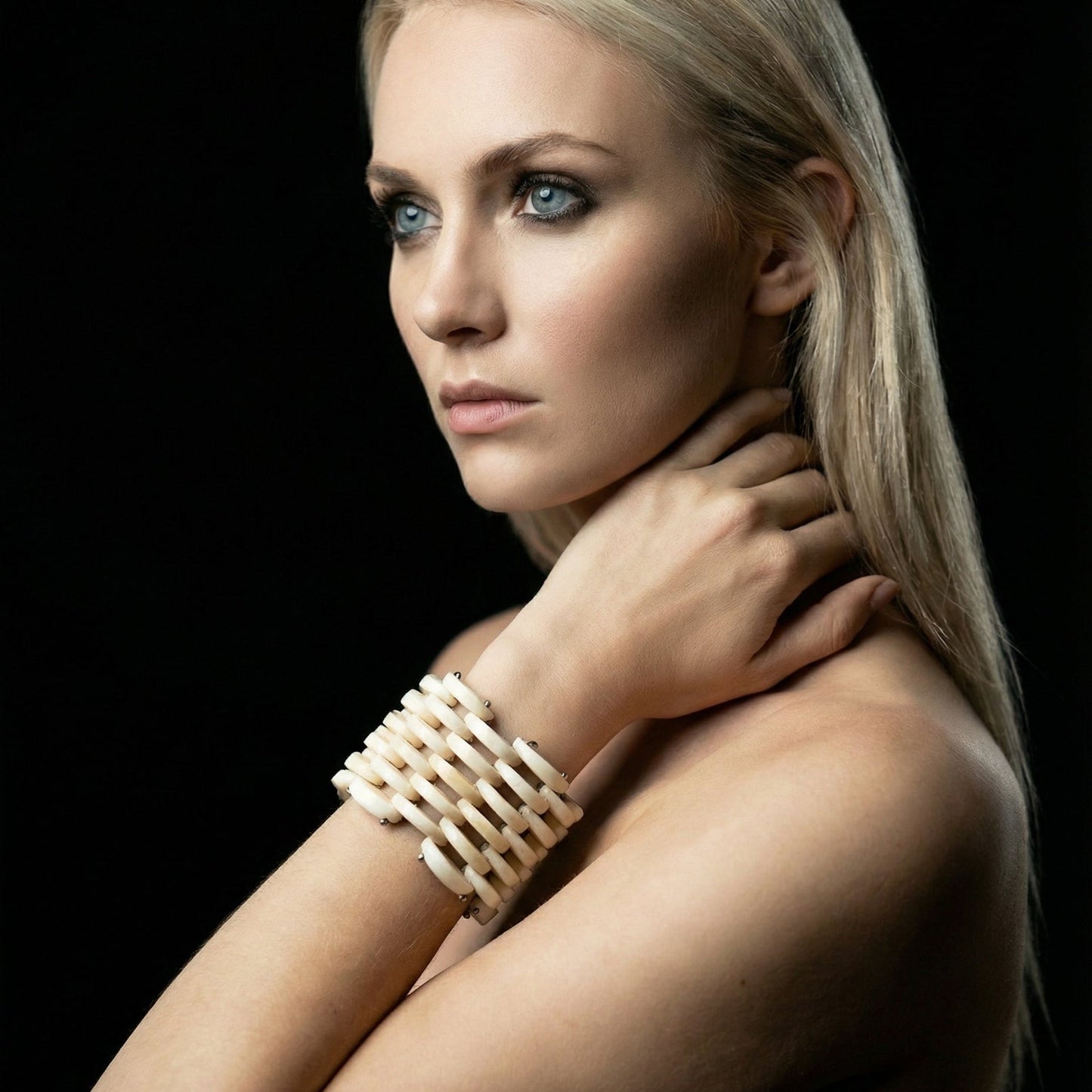 Woman wearing a bracelet on a black background